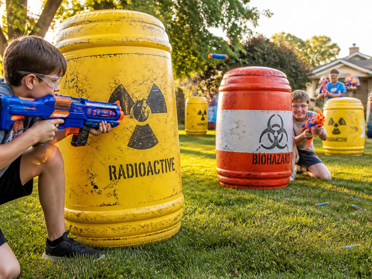 Kids playing a Nerf battle behind inflatable barricades at a Chicagoland birthday party